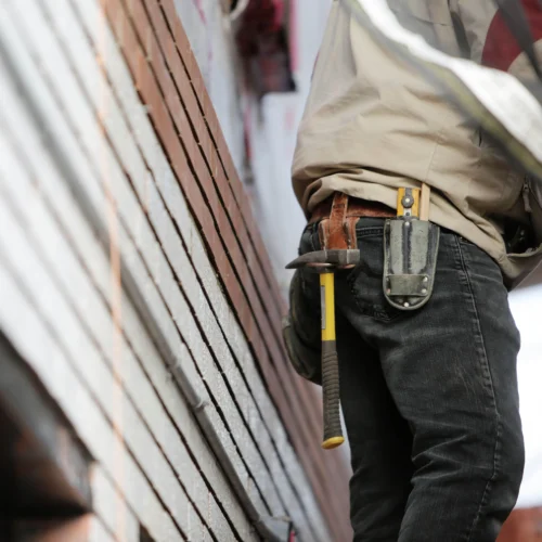 Contractor inspecting exposed framing during an older Bay Area home renovation