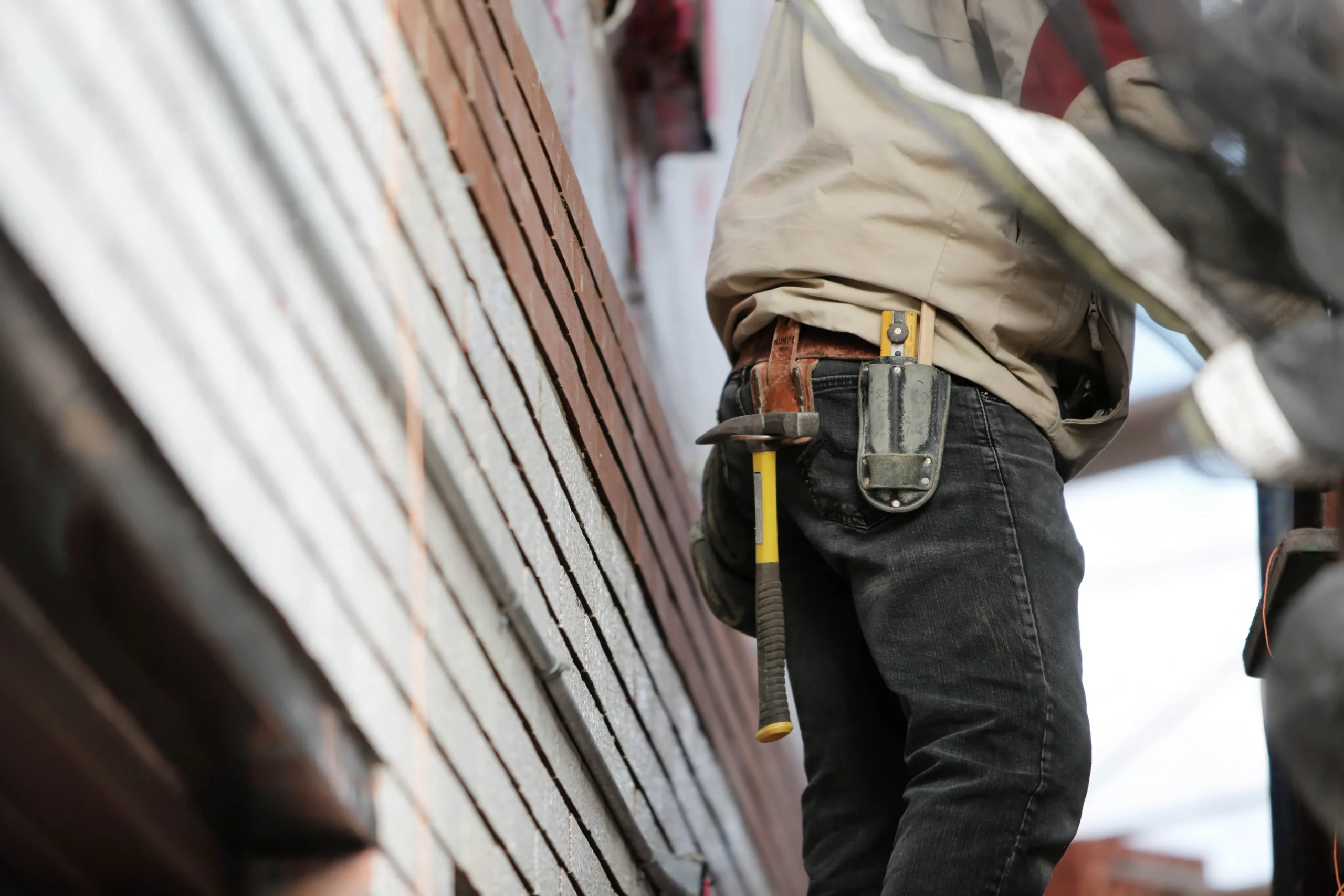 Contractor inspecting exposed framing during an older Bay Area home renovation